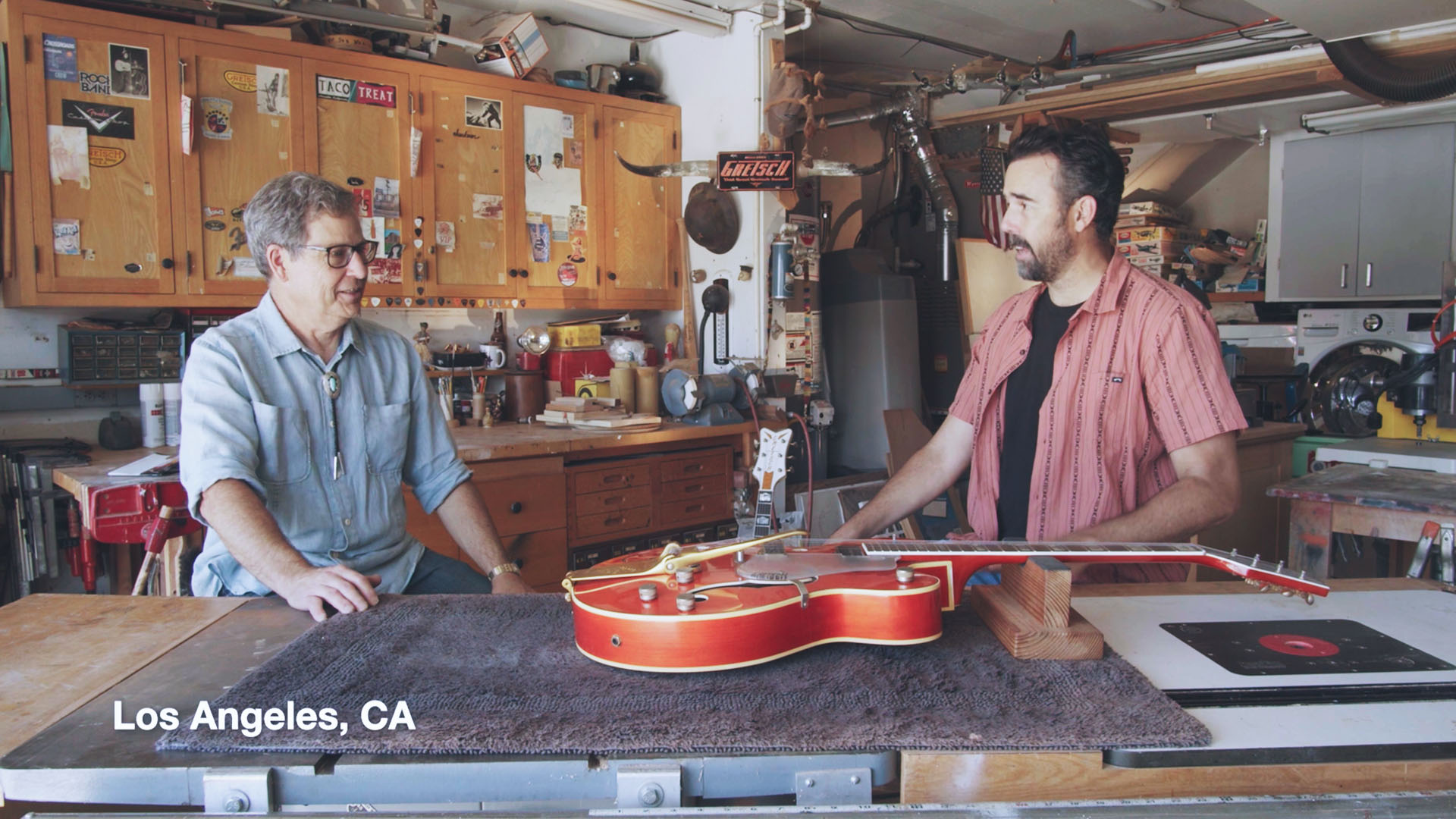 Tim Carey and Stephen Stern discussing a guitar build inside a Gretsch workshop in Los Angeles